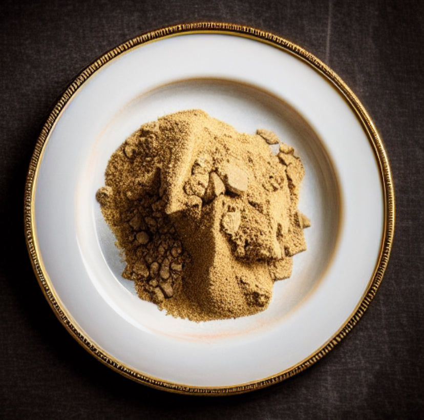 Fermented soybean powder on a white plate with gold rim against a dark background
